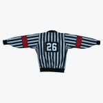 The back of a black and white striped referee jersey with the number 26 on the back and red bands on the sleeves.