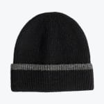A black knit beanie hat with a folded-up cuff featuring a thin grey stripe, isolated on a white background.
