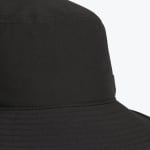 Close-up view of the crown and brim of a black bucket hat, showing fabric texture and stitching details.