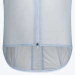 A close-up view of the lower portion of a translucent light blue cycling jacket, showing the central zipper and the curved drop tail hem.