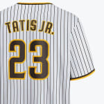 The back of a white pinstriped baseball jersey with TATIS JR. and the number 23 in brown and yellow lettering.