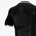 Close-up of the back of a black sports jersey featuring a subtle geometric pattern, with green and white trim on the collar and sleeve cuff.