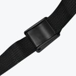 Close-up of a black plastic slide buckle on a black woven nylon strap against a white background.