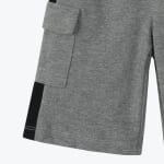 Close-up of grey knit cargo shorts featuring a side pocket with a flap and a black side stripe.