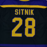 The back of a dark blue sports jersey displaying the name SITNIK and the number 28 in yellow with purple trim.