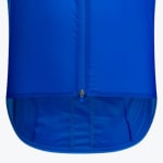 Close-up of the bottom hem and zipper of a bright blue cycling jersey showing the dropped tail design.