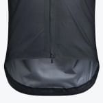 Close-up of the bottom hem and zipper of a dark grey technical cycling jacket, showing the ripstop fabric texture and a dropped tail hem with a lighter grey interior.