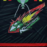 Close-up of a black sports jersey featuring a stylized green crystal comet logo with the word KRYPTONITE in bold lettering and white lace-up collar details.