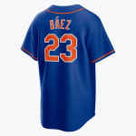 Back view of a royal blue baseball jersey with the name BÁEZ and number 23 in orange and white.