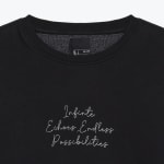 Close-up of a black crewneck sweatshirt with white embroidered cursive text reading Infinte Echoes Endless Possibilities on the chest.