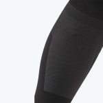Close-up of a black compression sleeve with a textured grey panel against a white background.