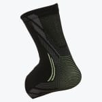 A black and grey knitted compression ankle sleeve with lime green accents, displayed against a white background.