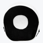 A round black and white leather boxing focus mitt with a white target circle in the center, isolated on a white background.