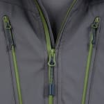 Close-up view of a grey technical jacket showing the main green zipper and two side pocket zippers with green pull tabs.