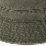 Close-up view of the textured olive green fabric and stitched brim of a bucket hat.