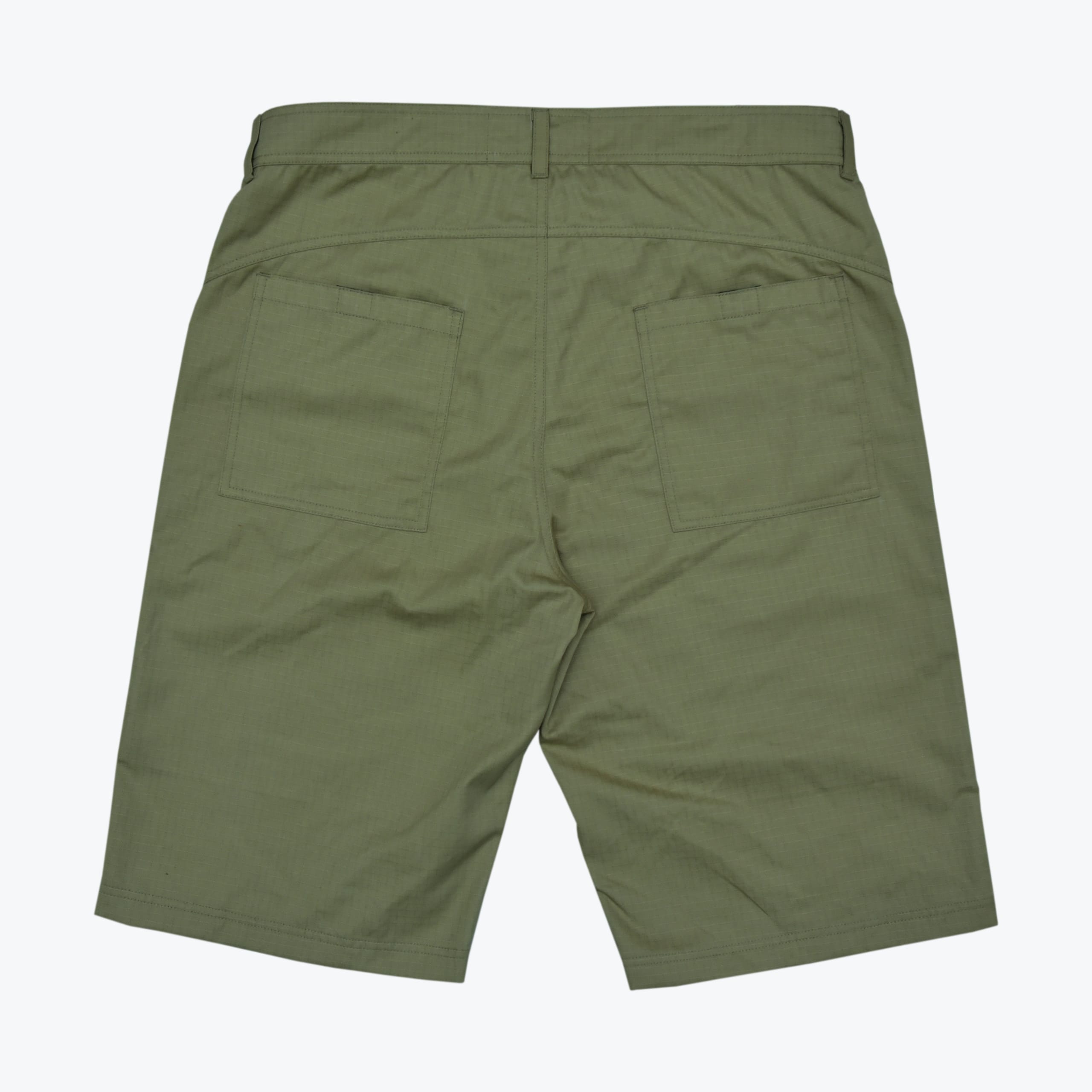 The back view of a pair of olive green shorts featuring two large rear patch pockets, belt loops, and a clean hem on a white background.