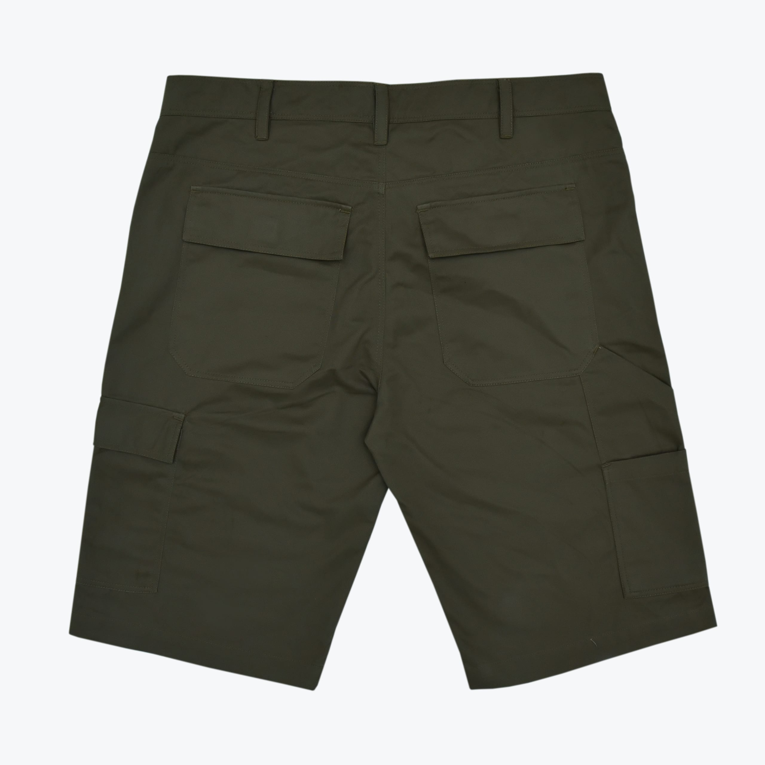 Back view of dark olive green cargo shorts with flap pockets and belt loops on a white background.