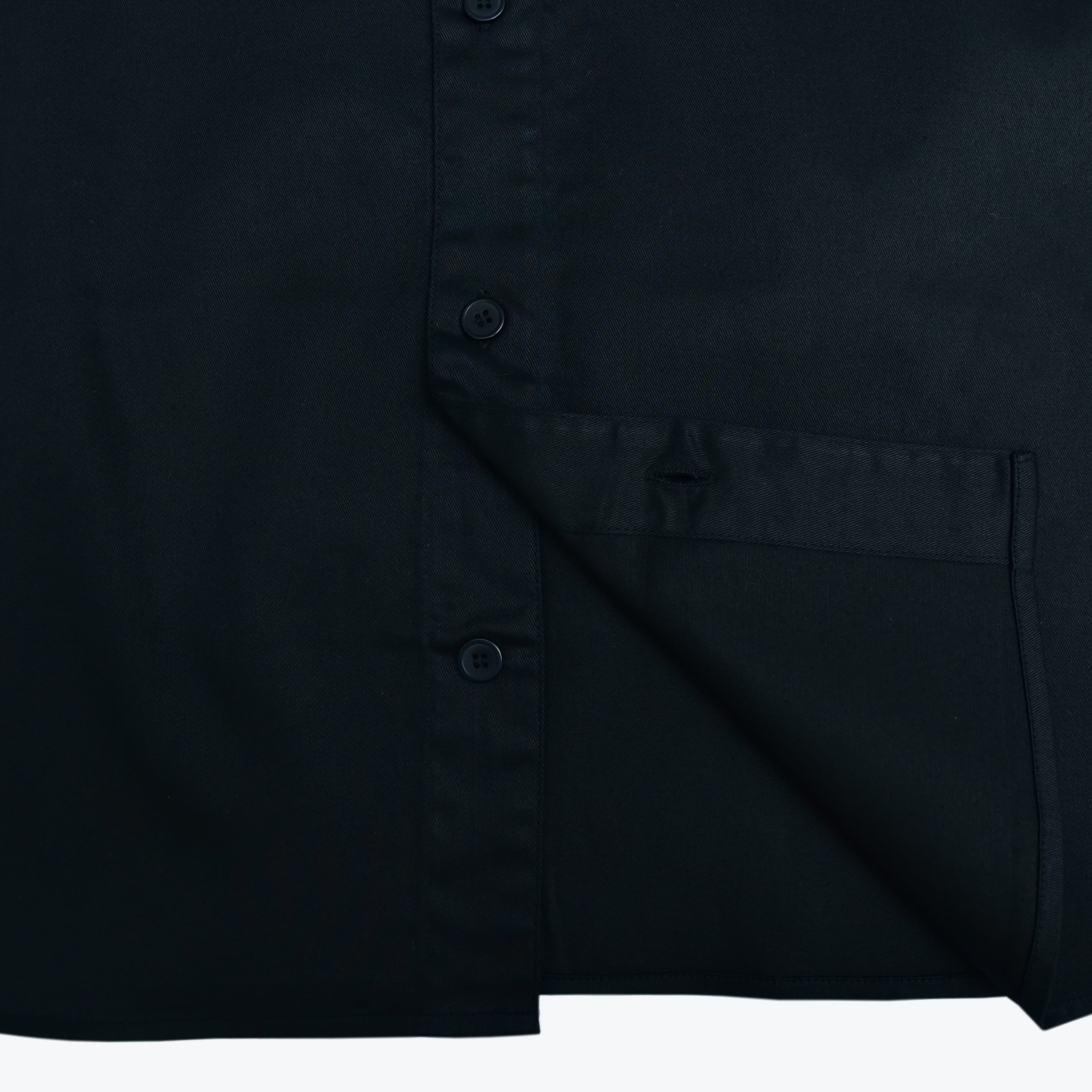 A close-up view of a black button-down shirt showing the button placket and bottom hem.