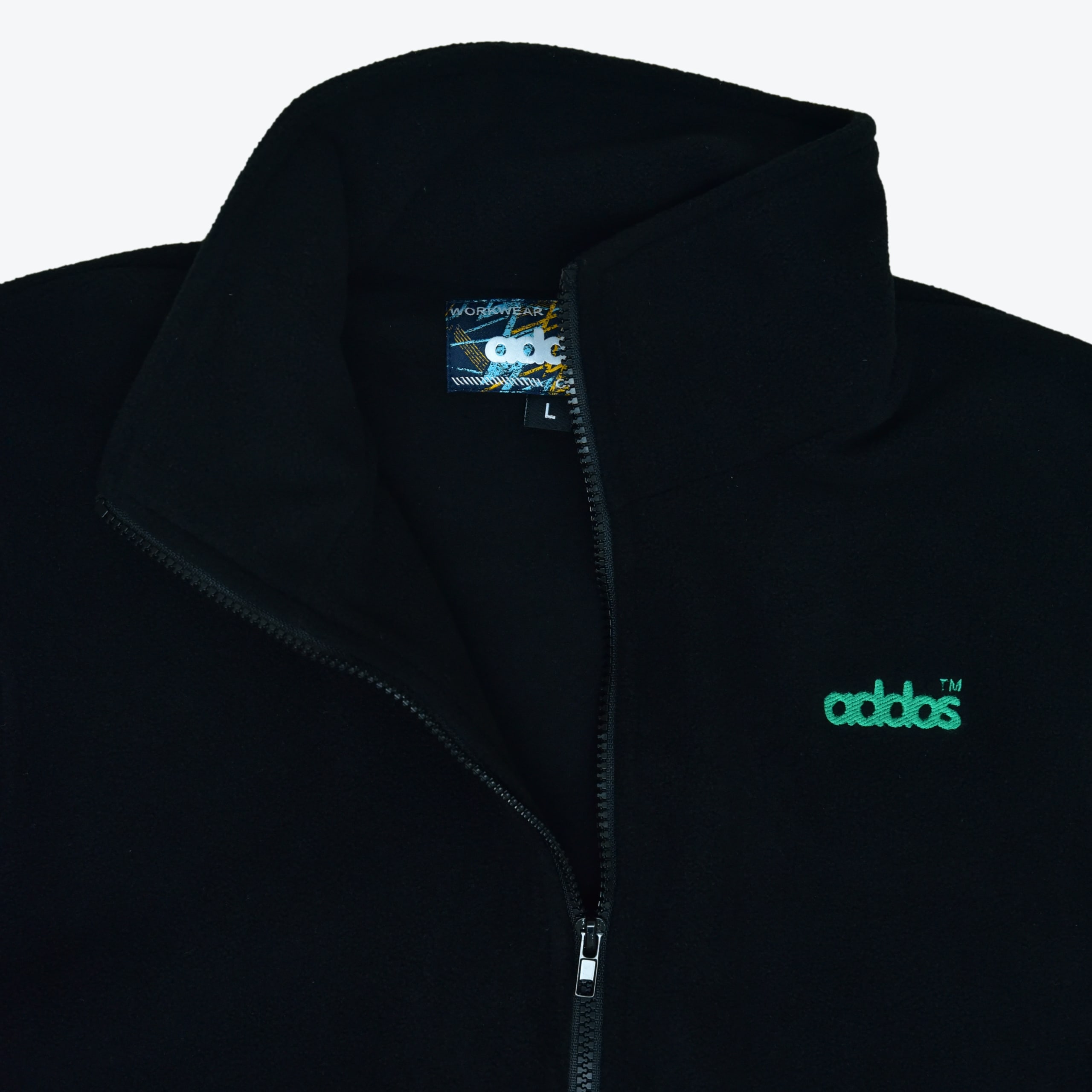 Close-up of a black fleece jacket with a high collar, a zipper, and a green embroidered addos logo on the chest.