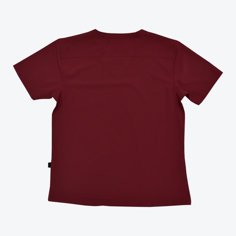The back view of a solid maroon short-sleeved scrub top with a horizontal yoke seam across the upper back, displayed flat on a white background.