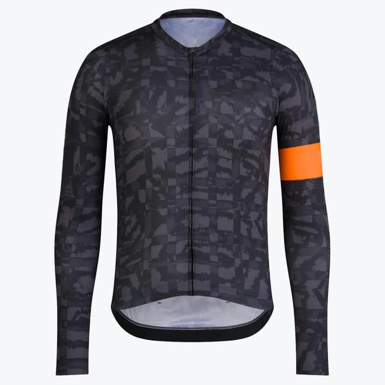 A dark grey patterned long-sleeve cycling jersey with a bright orange band on the left sleeve, displayed against a plain white background.