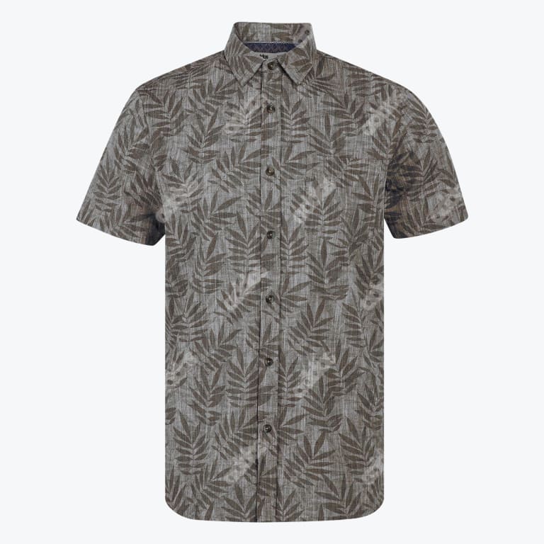 A mens short sleeved button down shirt in a muted grey brown color with an all over dark grey tropical leaf pattern displayed against a plain white background