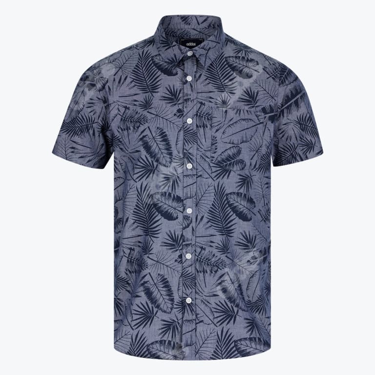 A mens short sleeve button down shirt in slate blue with a dark navy tropical leaf pattern featuring white buttons and a chest pocket