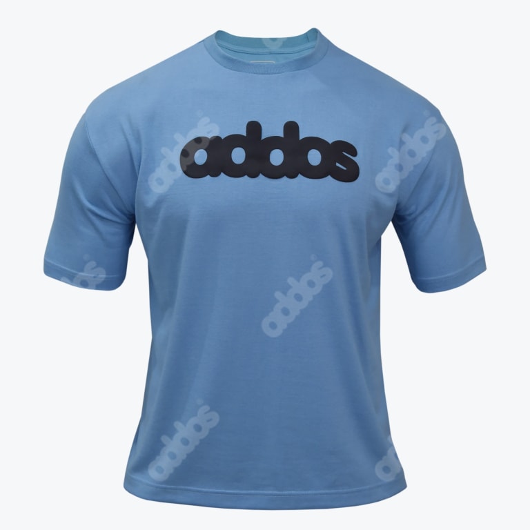 A light blue crew neck t shirt with a bold black addas logo on the chest and faint diagonal watermark logos printed on the fabric