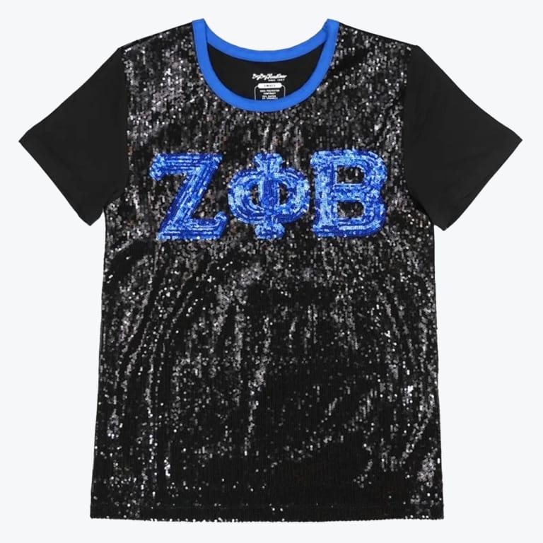 A black short-sleeve t-shirt with a black sequined front panel, featuring the Greek letters Zeta Phi Beta in blue sequins and a blue crew neck collar.