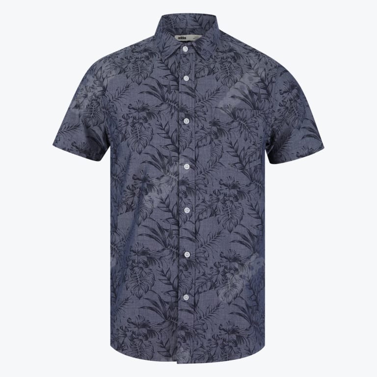 A dark blue mens short sleeve button up shirt with a grey tropical leaf pattern on a white background
