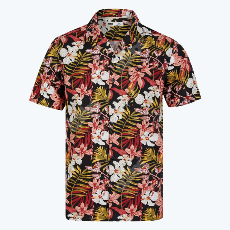A short-sleeved black button-up shirt with a colorful tropical print of white and pink flowers and green palm leaves.