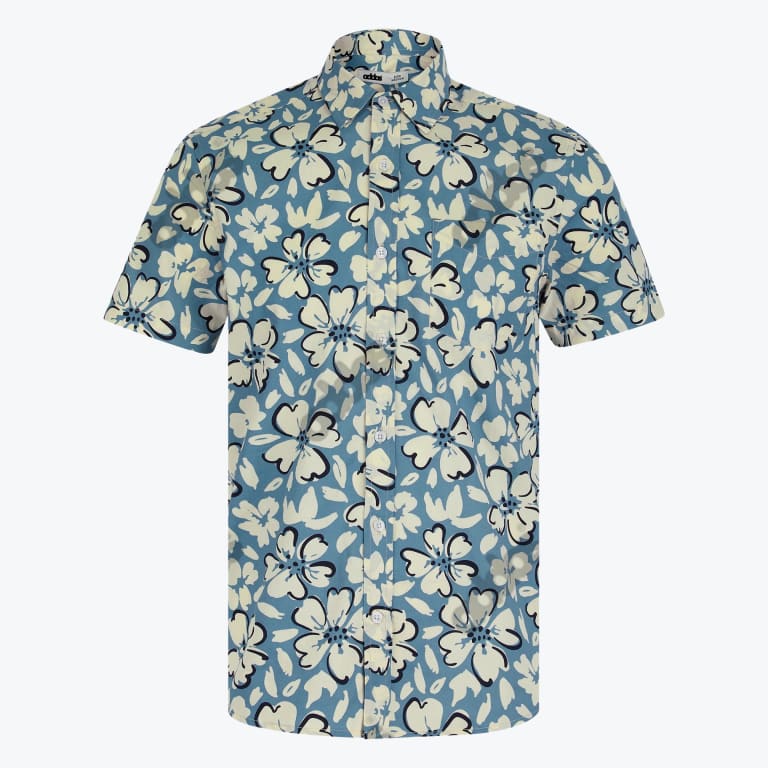 A short-sleeved button-up shirt with a dusty blue background and an all-over cream floral pattern.