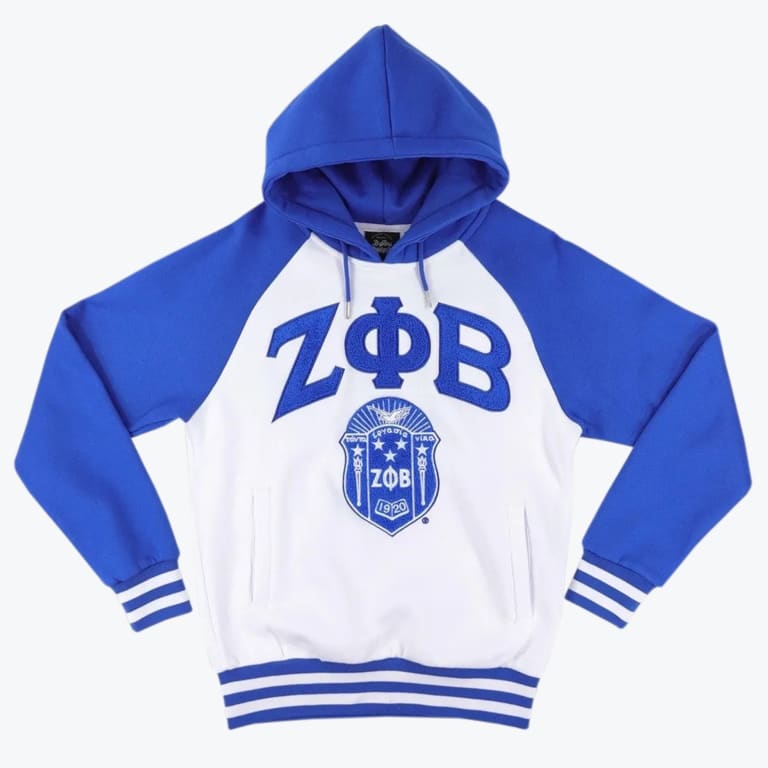 A royal blue and white raglan hoodie with the Greek letters ZΦB and the Zeta Phi Beta shield embroidered on the front.