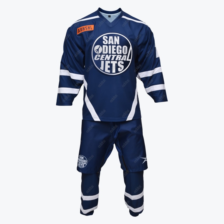 Front view of a dark blue San Diego Central Jets hockey jersey, pants, and socks set with white stripes and a circular team logo.