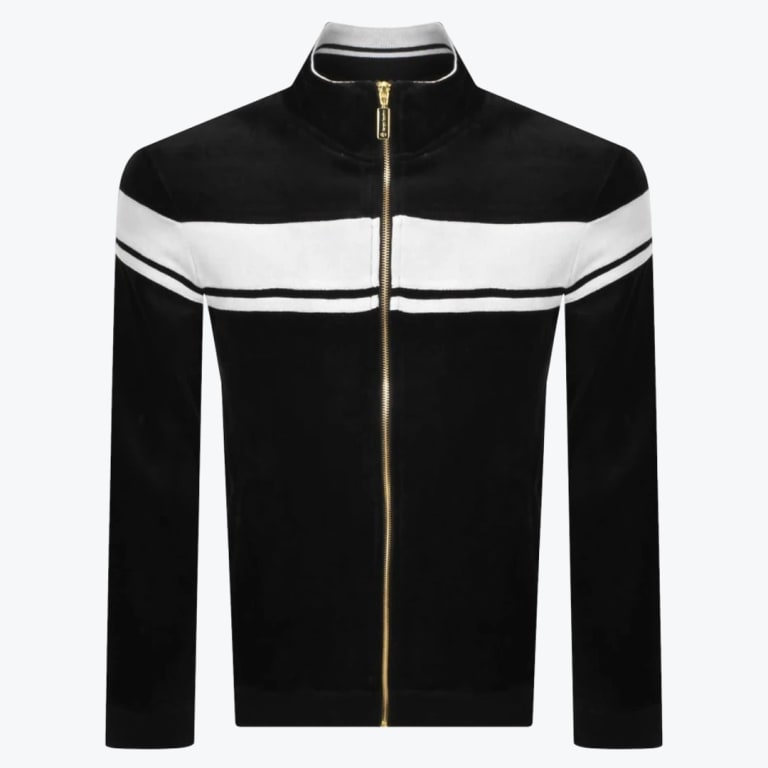 A front-facing studio shot of a black velour track jacket with a gold zipper, featuring a thick white stripe and a thin white stripe running horizontally across the chest and sleeves.