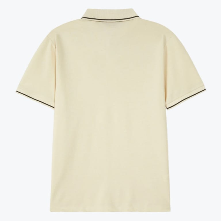 Back view of a cream-colored short-sleeved polo shirt with black stripes on the collar and cuffs, set against a plain white background.