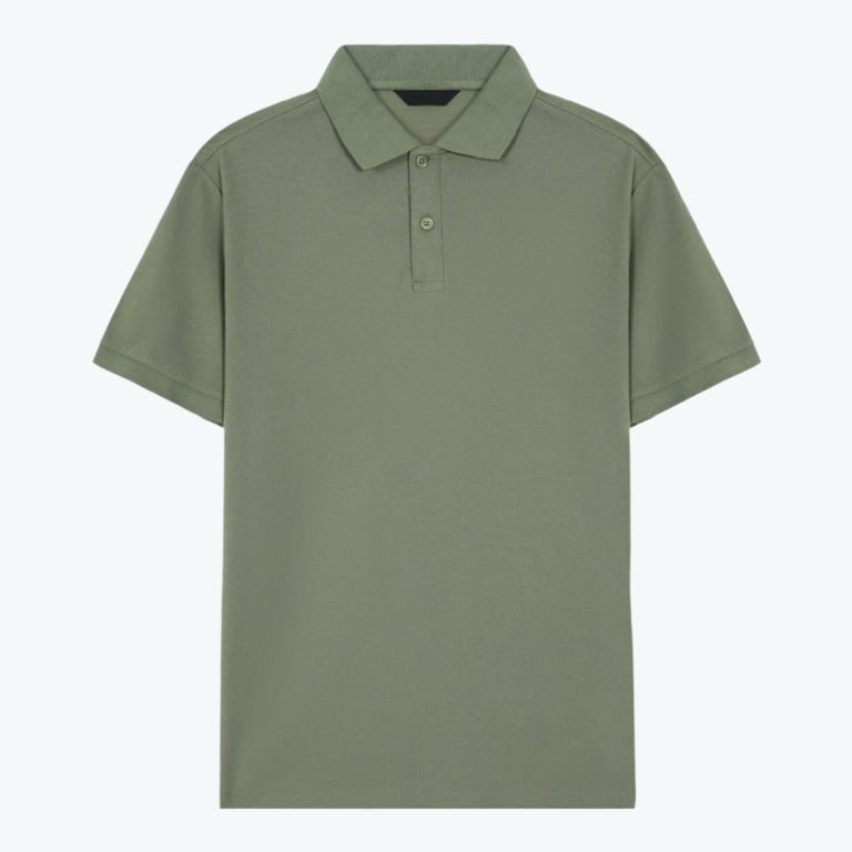 A flat lay studio shot of a short-sleeved sage green polo shirt with a two-button collar on a plain white background.