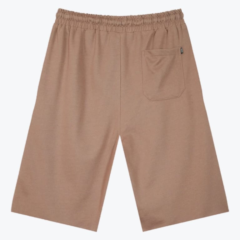 Back view of a pair of tan wide-leg casual shorts with an elastic waistband and a single back pocket on a plain white background.