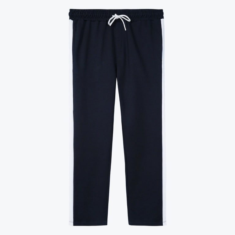 Navy blue track pants with white side stripes and a white drawstring on a white background.