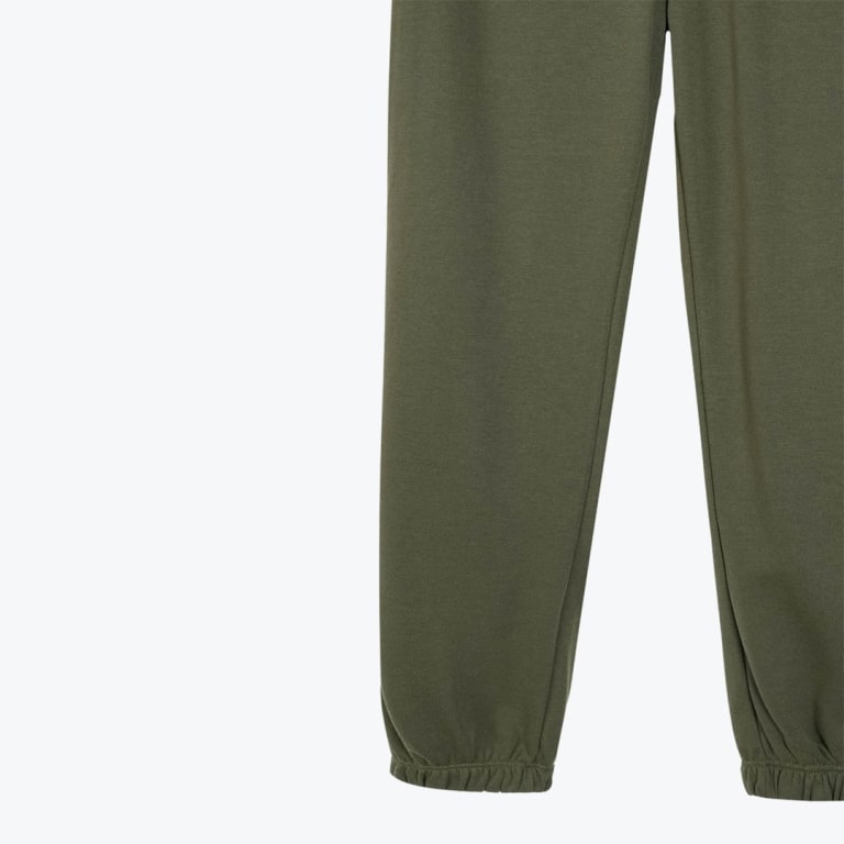 Close-up of olive green sweatpants legs with elastic cuffs on a white background.