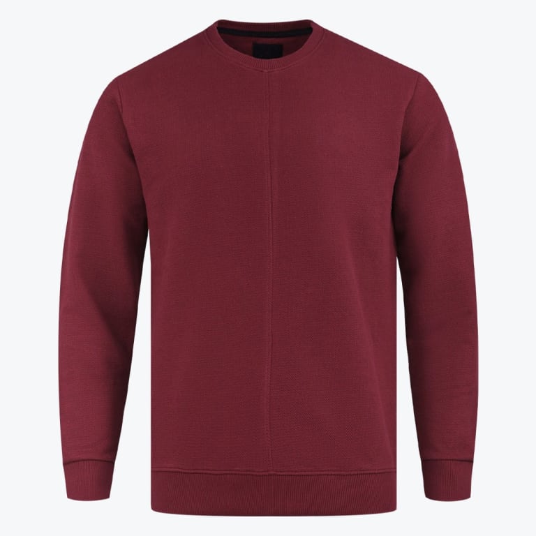 A maroon crewneck sweatshirt with a vertical center seam, ribbed cuffs, and a ribbed hem, displayed against a solid white background.