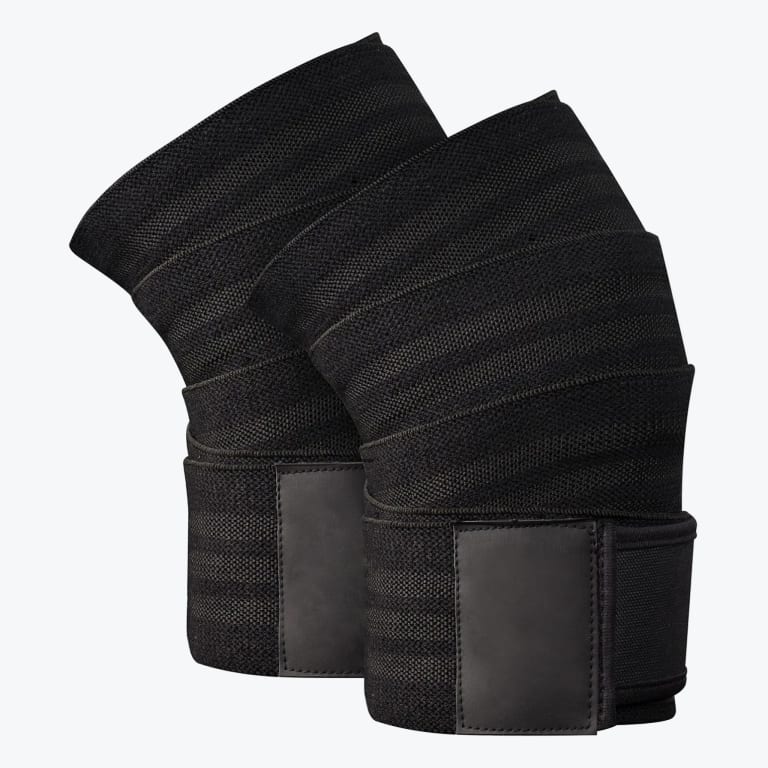 A pair of black elastic knee wraps with velcro fasteners, designed for weightlifting support, displayed on a white background.