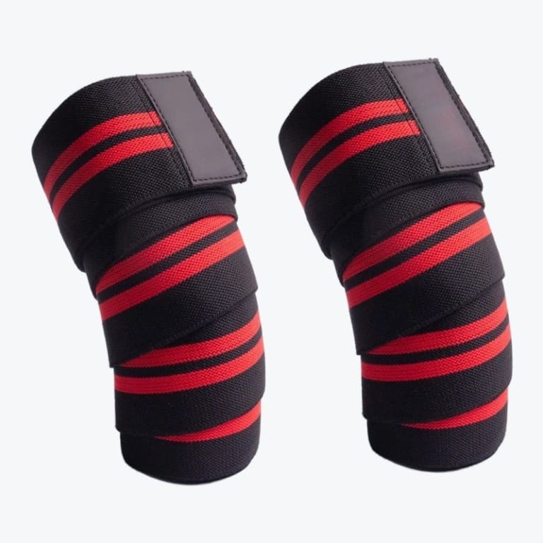 A pair of black and red elastic knee wraps for weightlifting, shown wrapped in a cylindrical shape against a plain white background.