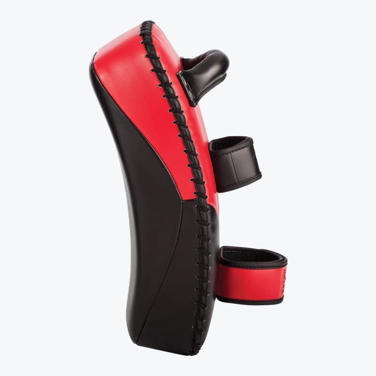 A side view of a red and black curved Thai kick pad with adjustable arm straps against a white background.