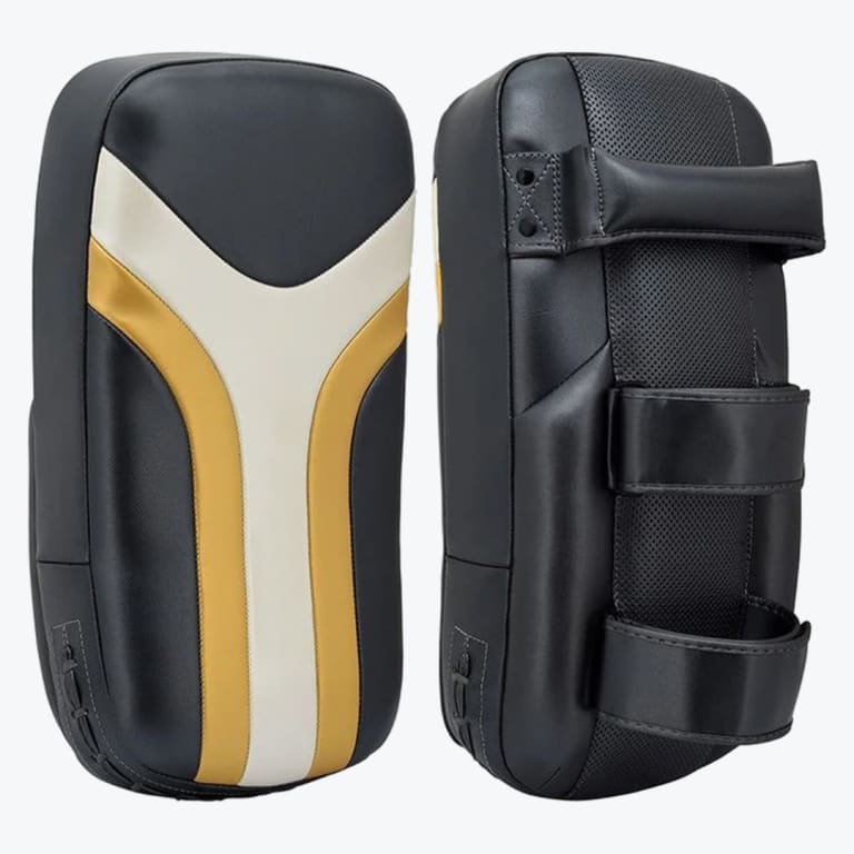 Front and back views of a pair of black, white, and gold martial arts Thai kick pads against a white background.