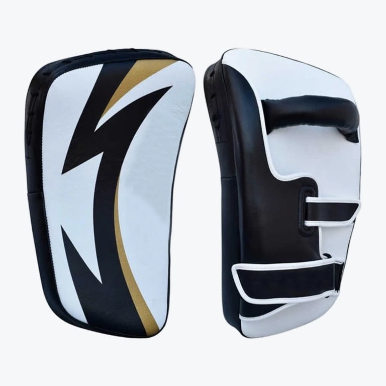 Front and back view of a pair of black, white, and gold curved Thai kick pads used for martial arts training.