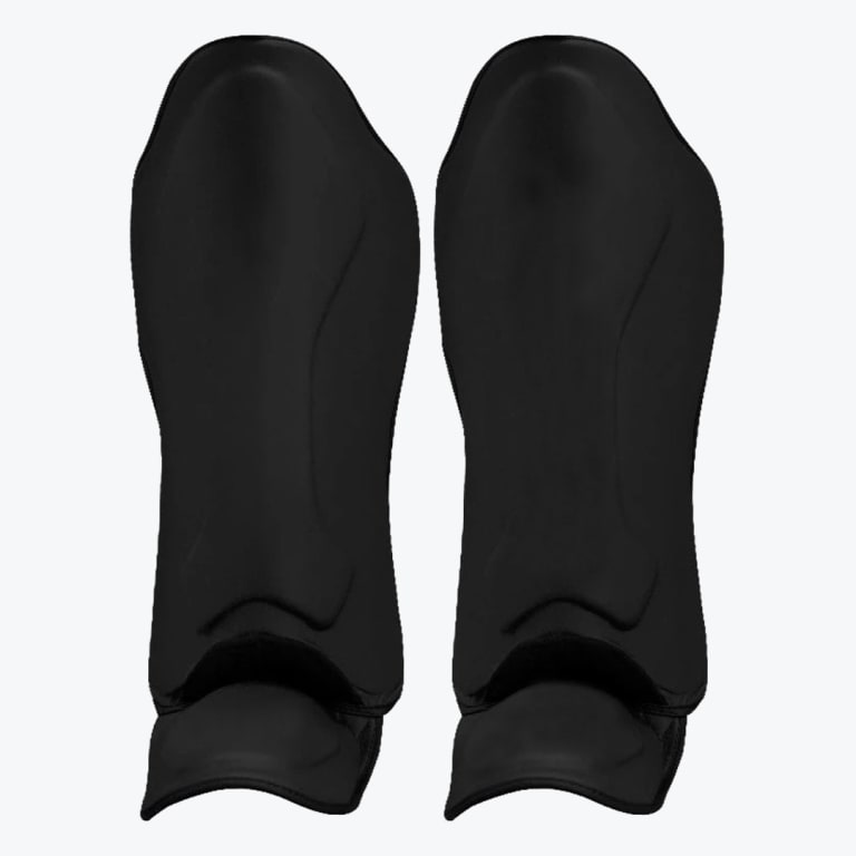 A pair of solid black athletic shin guards with built-in ankle sleeves on a white background.