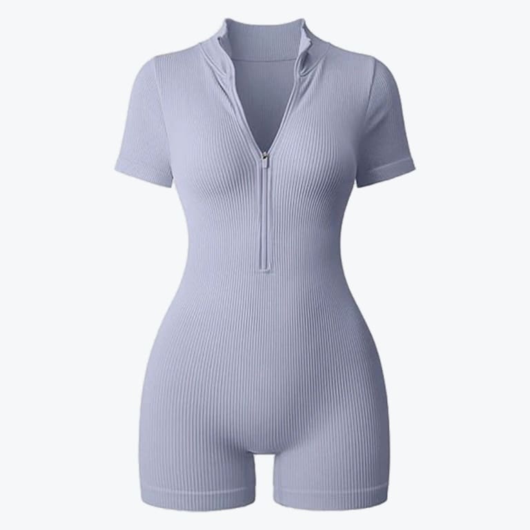A light lavender ribbed short-sleeve romper with a front zipper closure on a plain background.