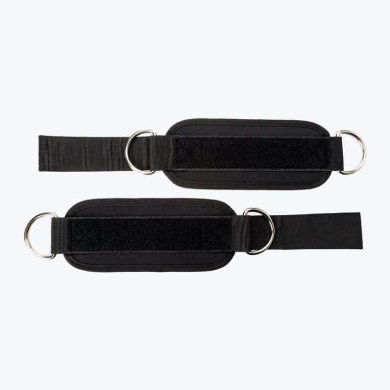 Two black padded ankle straps with silver D-rings and velcro fasteners, laid out horizontally against a white background.