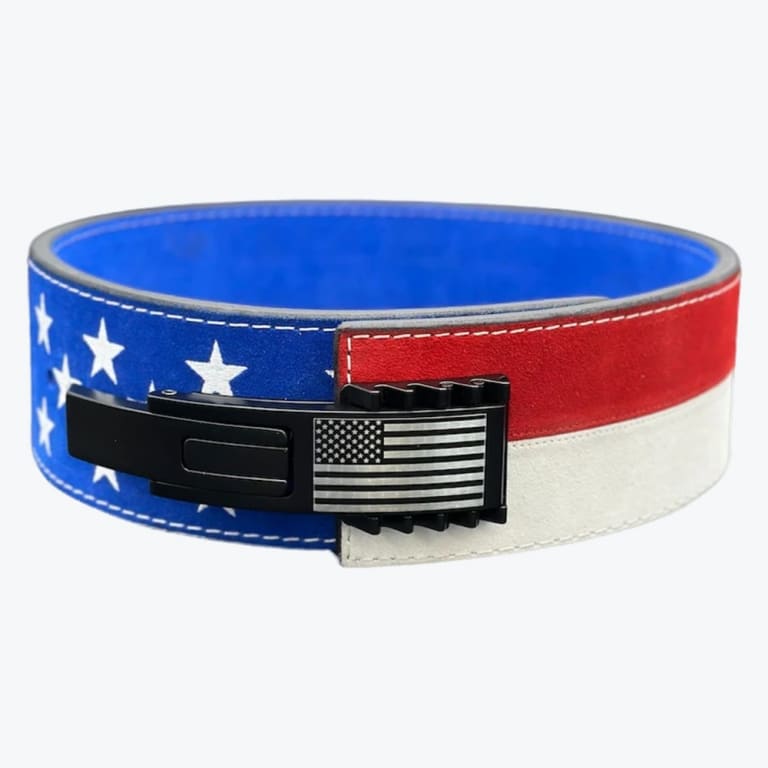 A weightlifting belt with an American flag design, featuring blue suede with white stars on one half and red and white stripes on the other, fastened with a black lever buckle engraved with a US flag.